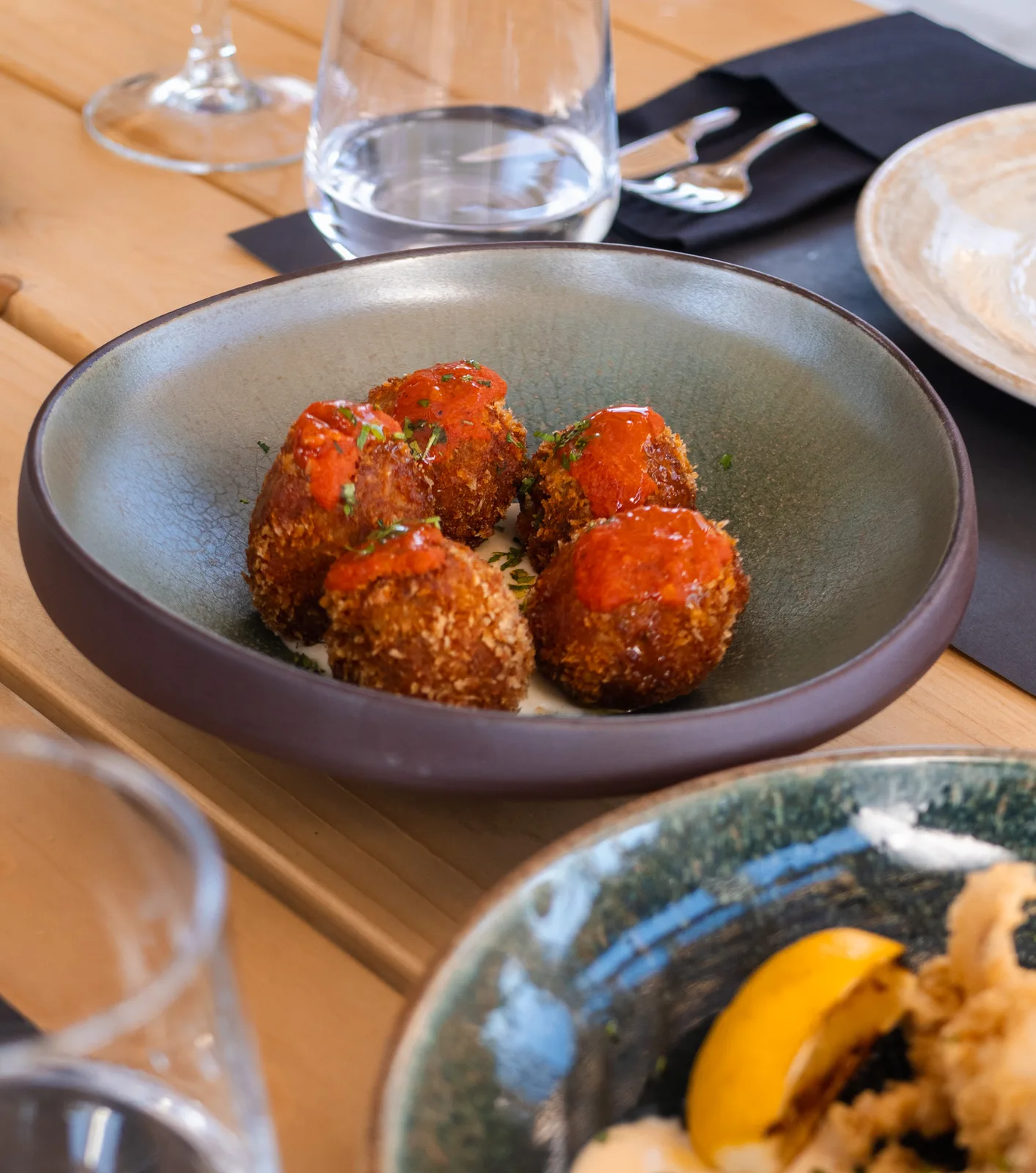 Golden bites served with tomato sauce at Eterna