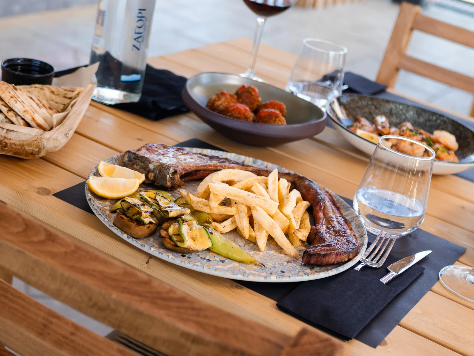 Greek dishes and wine on the table at Eterna
