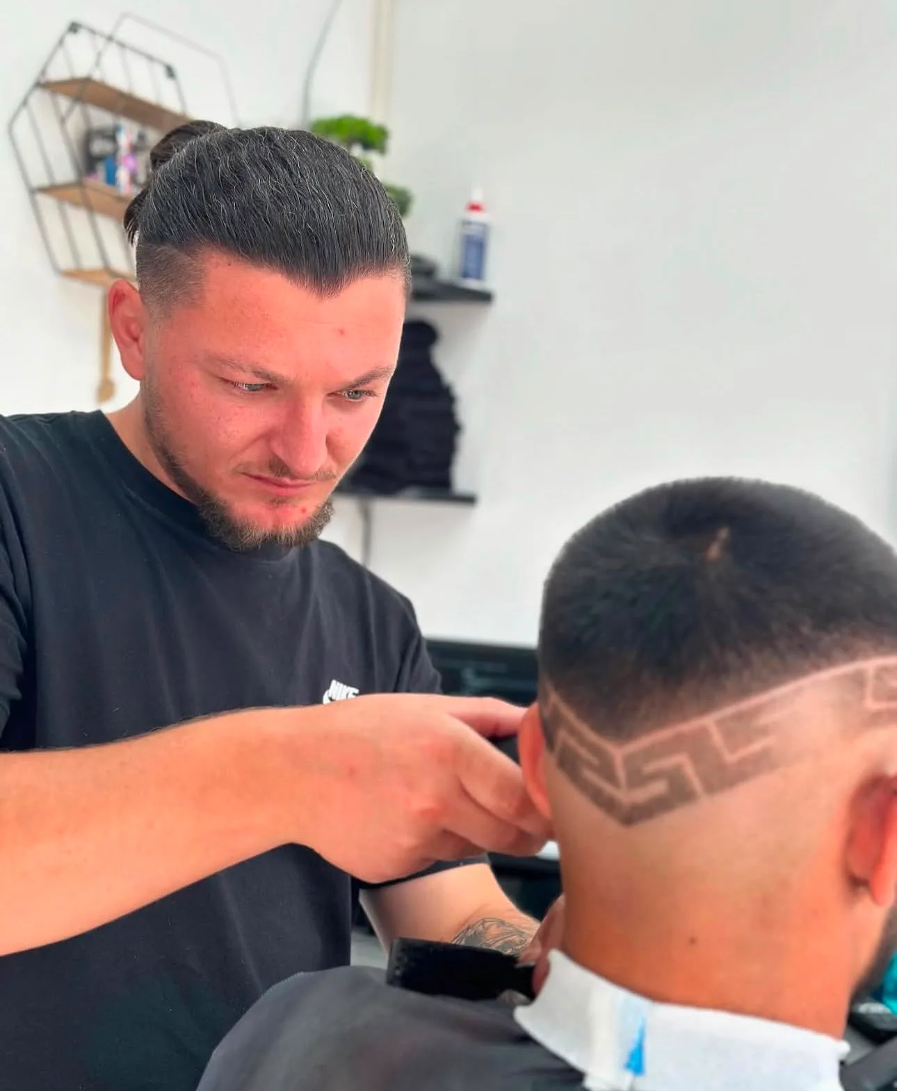 A Fade O’Clock barber working on a haircut