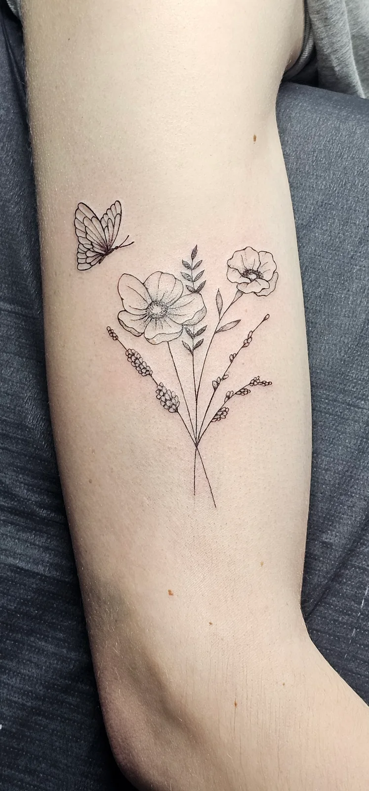 Fine line wildflower tattoo