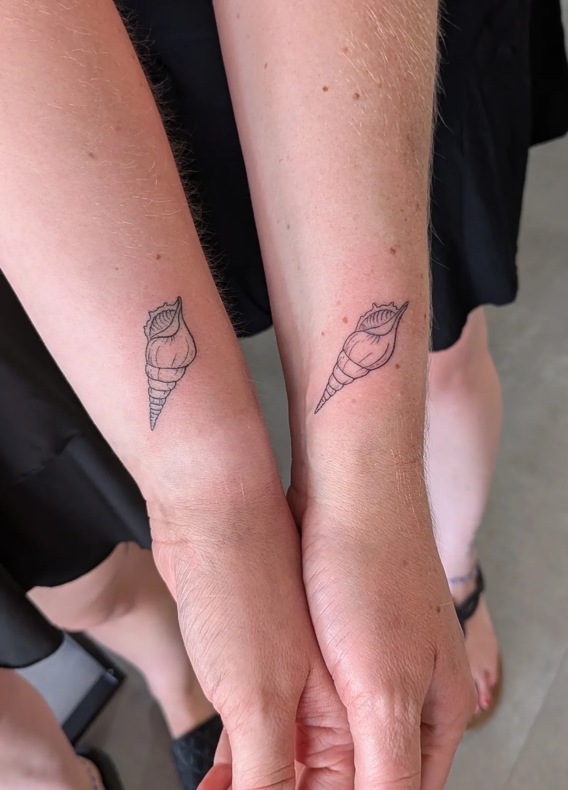 Matching fine line geometric tattoos