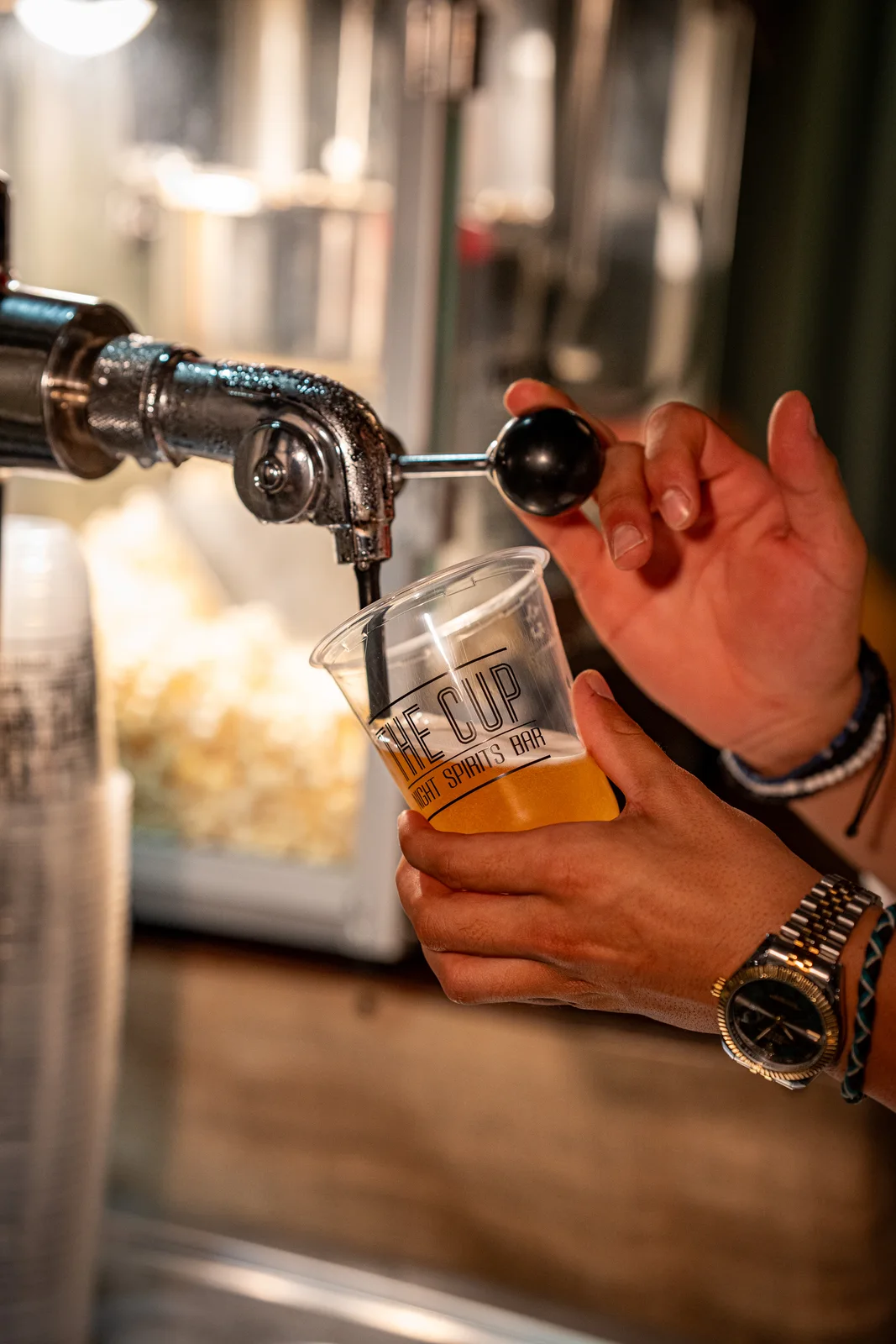 A drink being poured at The Cup