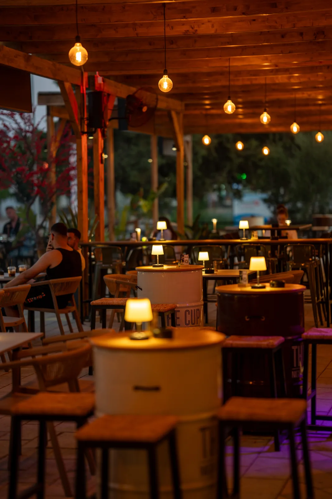 Warm evening lighting and tables at The Cup, Street Hall