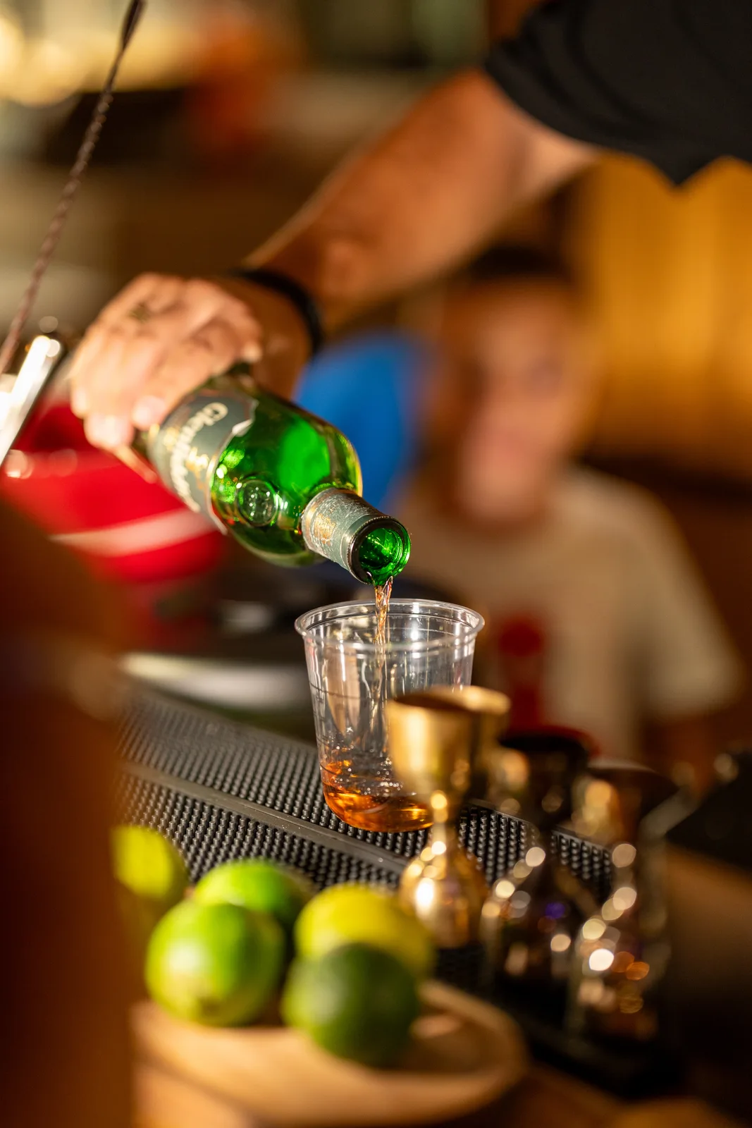 A bartender preparing a drink at The Cup